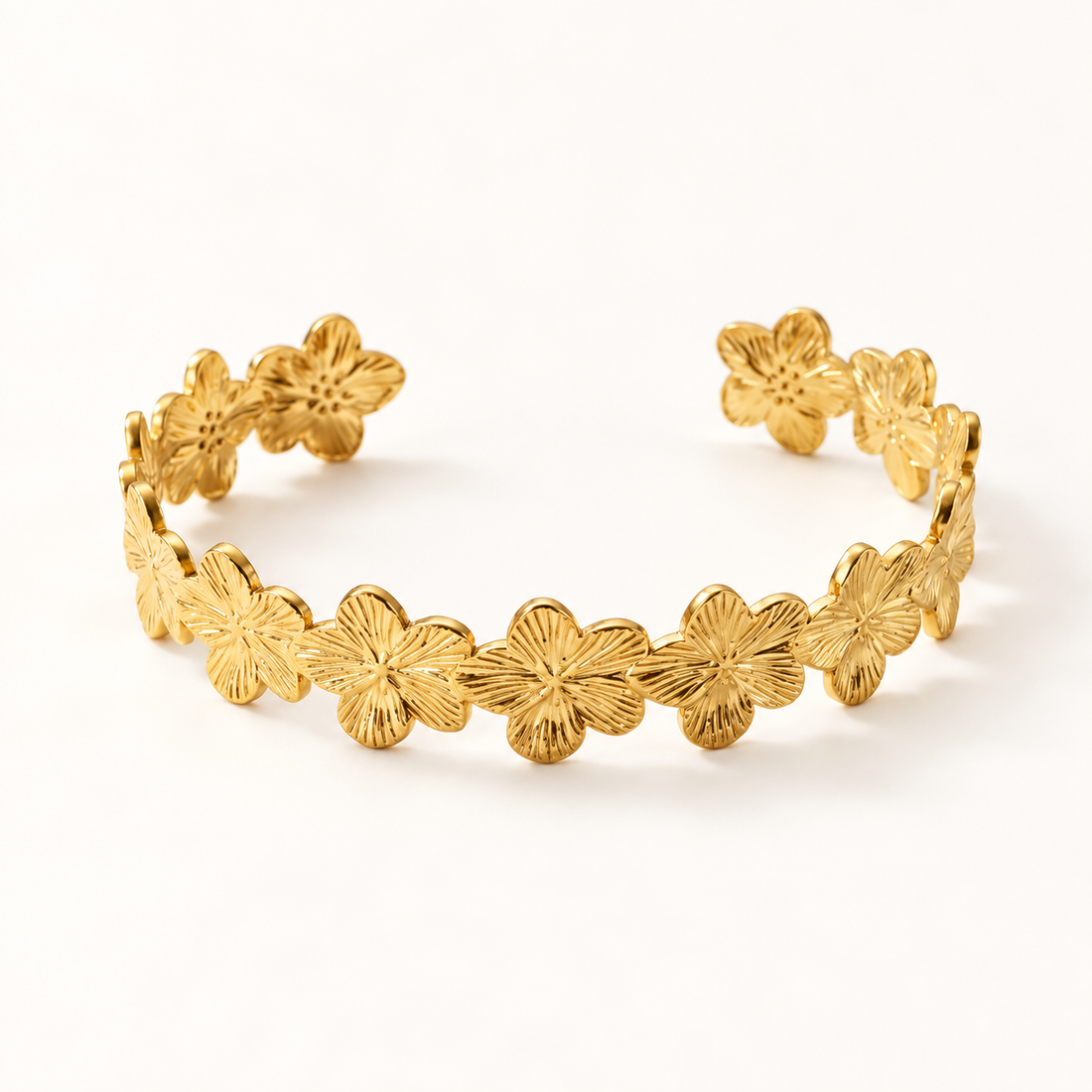 A gold forget-me-not flower chain bracelet with delicate linked floral charms, each petal detailed with textured centers, shown from front and side angles on a clean white background displaying the dainty chain links, spring blossom design, and polished gold finish.