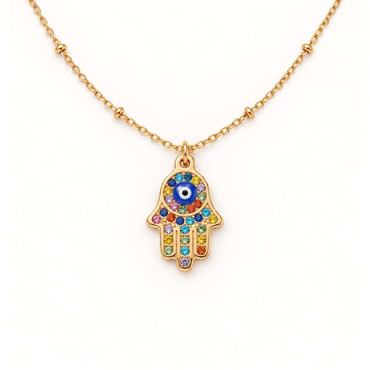 A gold Hamsa hand pave necklace with colorful crystal-encrusted palm, blue evil eye center, and rainbow stones on fingers, protective amulet design on delicate chain, shown from front and side angles on a clean white background displaying the vibrant multicolor sparkle, intricate hand detail, and polished gold finish.