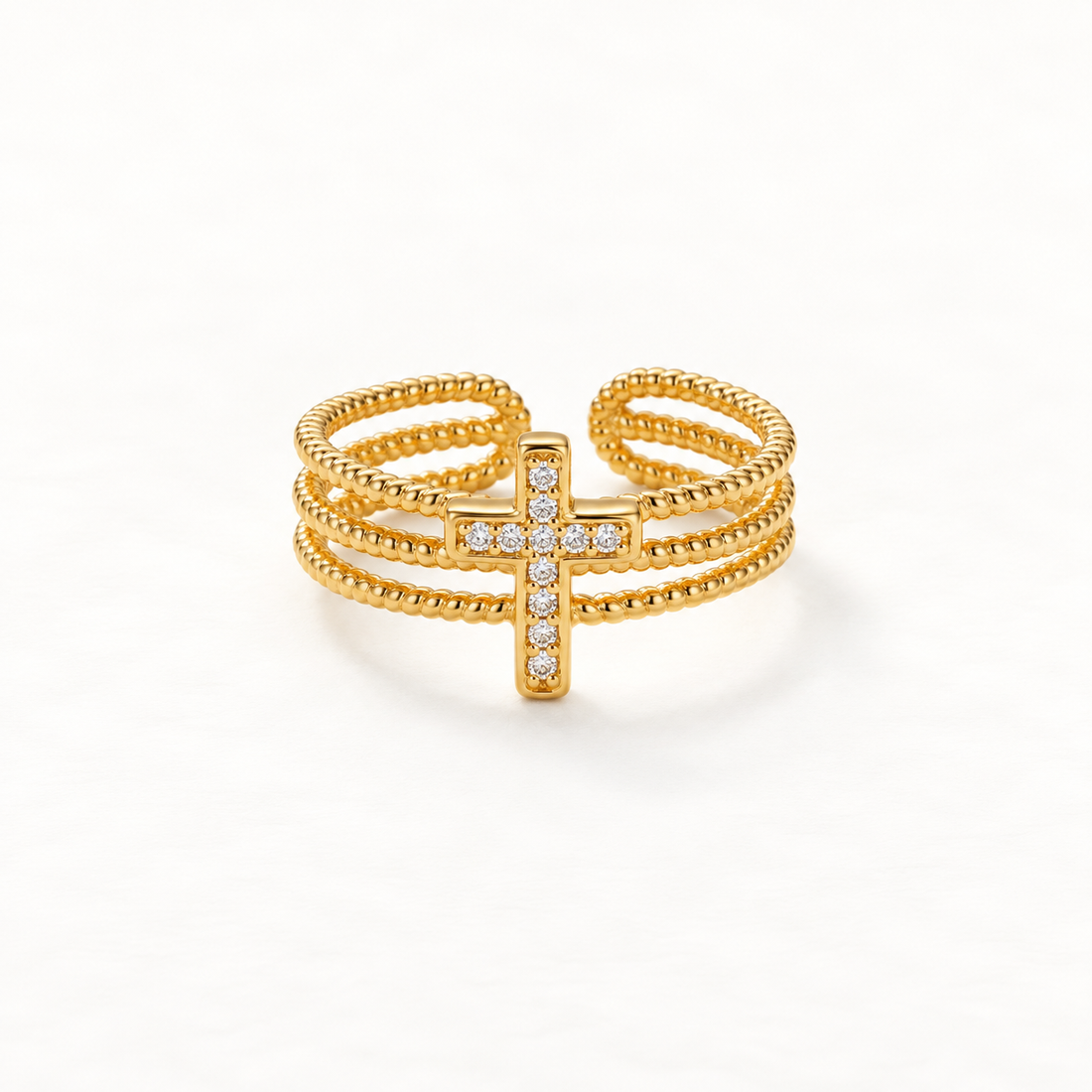 A gold beaded cross pave ring with three rows of ball chain bands and crystal-encrusted cross centerpiece, delicate open adjustable design, shown from front and side angles on a clean white background displaying the sparkling stone detail, textured beaded texture, and polished gold finish.