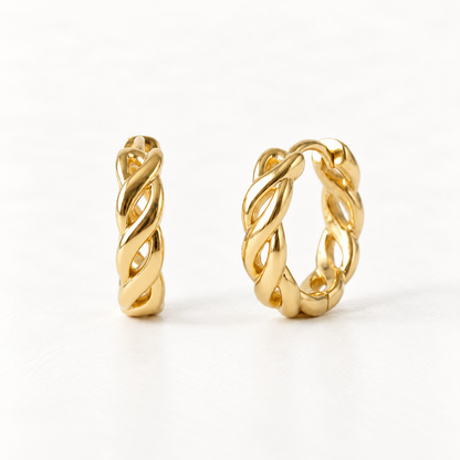 A pair of 18k gold braided twist huggie hoop earrings with intricate woven open pattern, shown from front and side angles on a clean white background displaying the detailed interlaced texture and hinged closure.