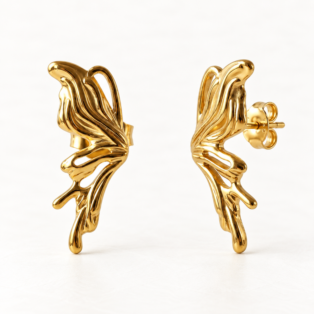 A pair of 18k gold butterfly wing stud earrings with detailed vein texture and organic shape, shown from front and side angles on a clean white background displaying the sculptural wing detail and post with butterfly backing.