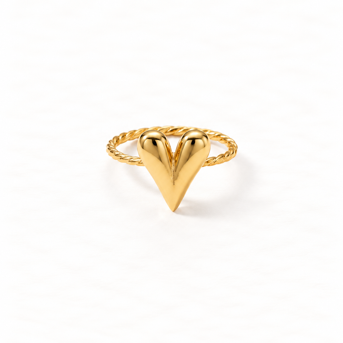A gold chevron heart ring with V-shaped arrow design forming a heart silhouette, twisted rope texture band, open adjustable design, shown from front and side angles on a clean white background displaying the geometric love symbol, intricate rope detail, and polished gold finish.