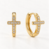 A pair of 18k gold cross-shaped huggie hoop earrings with clear pave crystals along the edges, shown from front and side angles on a clean white background displaying the hinged closure and sparkling stone detail.