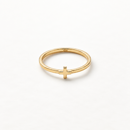 A gold cross ring with simple thin band and small centered cross symbol, delicate religious design with smooth polished surface, shown from front and side angles on a clean white background displaying the minimal spiritual symbolism, sleek band, and polished gold finish.