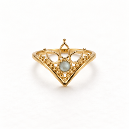 A gold crown tiara ring with intricate filigree details and iridescent moonstone center, regal princess design with pointed peaks and delicate metalwork, open adjustable band, shown from front and side angles on a clean white background displaying the royal symbolism, ornate lace-like texture, and polished gold finish.