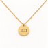 A gold 11:11 simple disc necklace with round pendant engraved in clean minimalist font and delicate cable chain, understated spiritual synchronicity design, shown from front and side angles on a clean white background displaying the timeless time detail, classic medallion form, and polished gold finish.