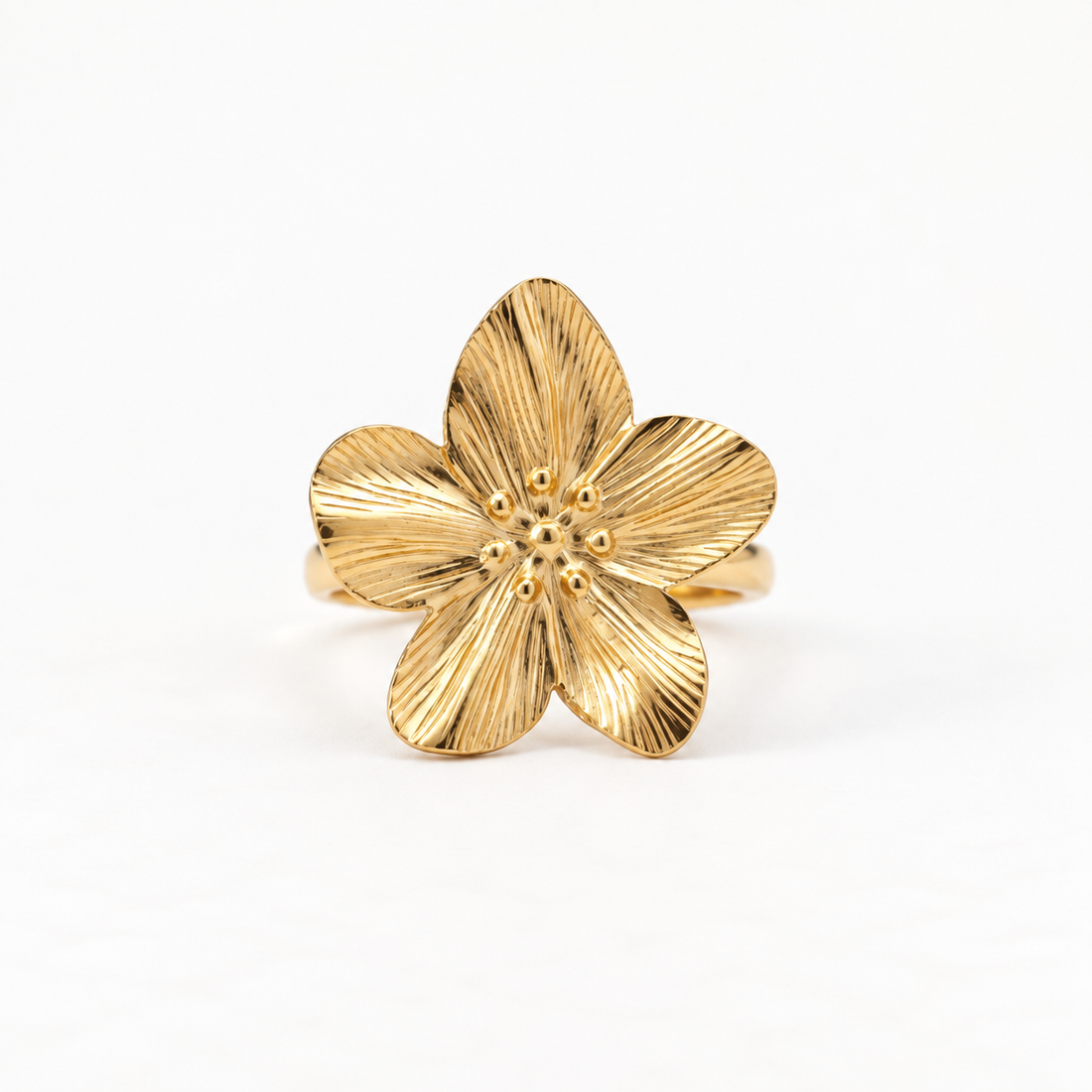 A gold five petal flower ring with detailed vein texture on each petal and textured center stamen, open adjustable band, shown from front and side angles on a clean white background displaying the botanical bloom design, intricate petal ridges, and polished gold finish.