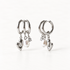 A pair of sterling silver huggie hoop earrings with dangling polished heart charms and white freshwater pearl accents, shown from front and side angles on a clean white background displaying the romantic charm detail and hinged closure.