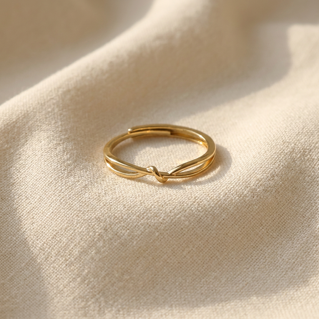 A gold infinity knot ring with continuous loop design forming a figure-eight love knot lying flat on a white background with soft natural shadows, showing the eternal connection symbolism, sleek interwoven form, and polished gold finish from above.