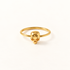 A gold skull ring with delicate band and small detailed skull centerpiece featuring hollow eye sockets and defined jawline, shown from front and side angles on a clean white background displaying the minimalist band, edgy yet feminine aesthetic, and polished gold finish.