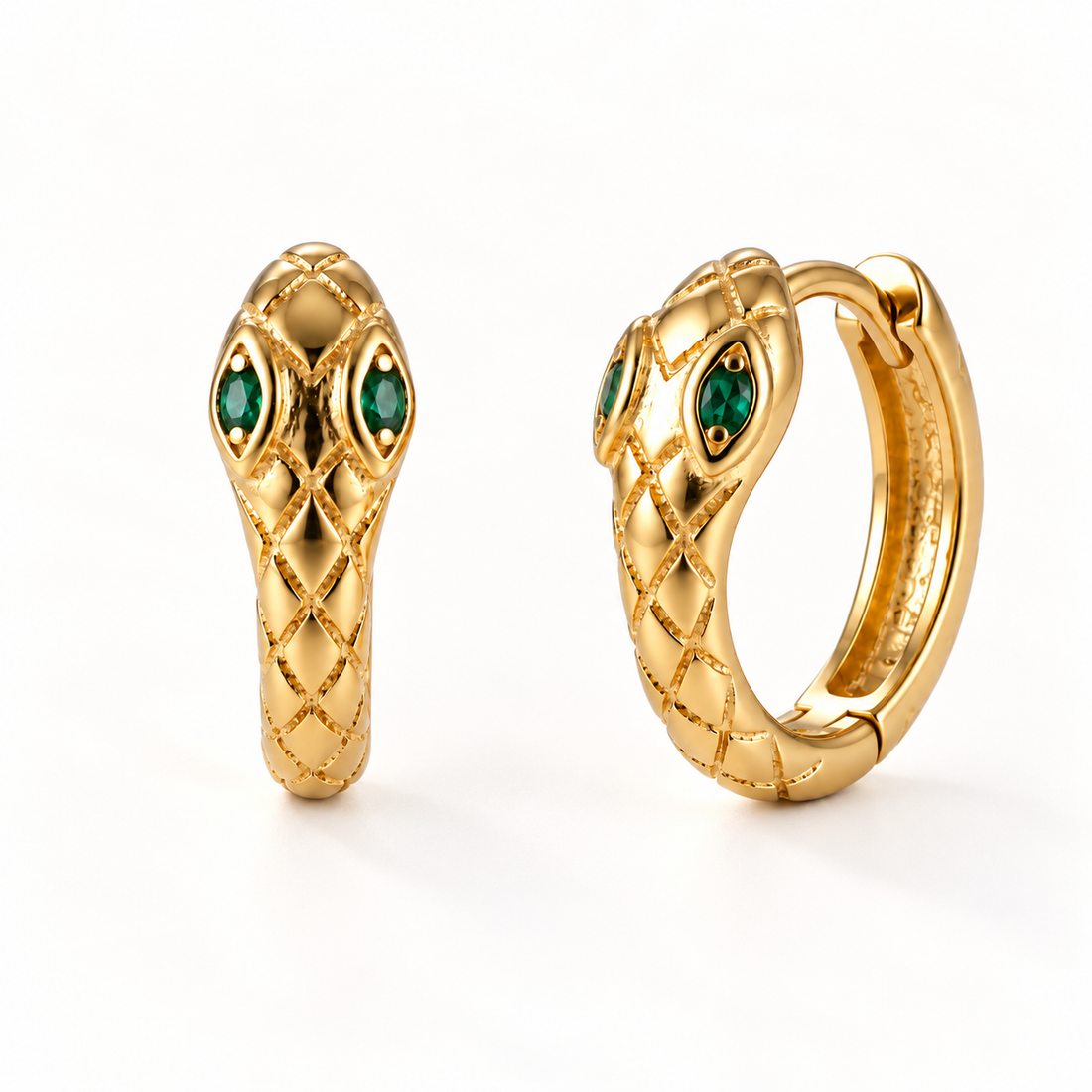 A pair of 18k gold snake-shaped huggie hoop earrings with emerald green stone eyes and textured scale pattern, shown from front and side angles on a clean white background displaying the hinged closure and detailed serpent head design.