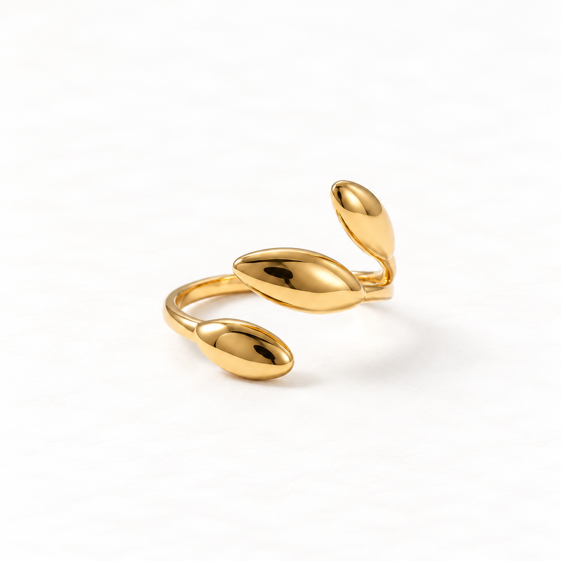 A gold sprout leaf ring with three oval botanical leaves emerging from open adjustable band, organic plant-inspired design with polished reflective surfaces, shown from front and side angles on a clean white background displaying the nature-inspired growth symbolism, sculptural leaf forms, and polished gold finish.
