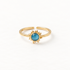 A gold sun ring with vibrant blue turquoise center stone and radiating sunburst rays, celestial open adjustable band with textured edges, shown from front and side angles on a clean white background displaying the bright blue hue, detailed ray texture, and polished gold finish.