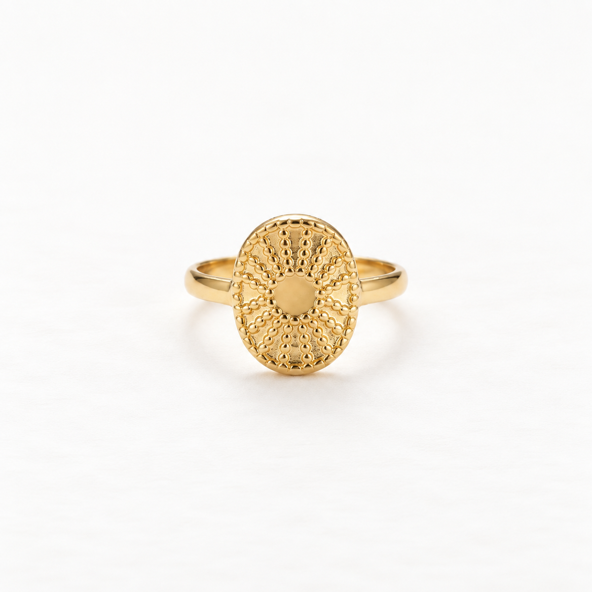 A gold sun coin filigree ring with intricate radiating pattern and smooth polished center, detailed metalwork sunburst design, open adjustable band, shown from front and side angles on a clean white background displaying the ornate celestial symbolism, delicate ray texture, and polished gold finish.