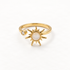 A gold sun ring with iridescent mother of pearl center stone and radiating rays, small clear crystal accent on band, open adjustable design, shown from front and side angles on a clean white background displaying the luminous pearl center, celestial symbolism, and polished gold finish.